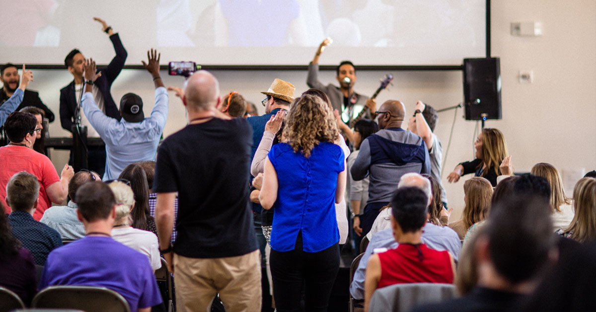 Educators cheer the band onstage